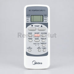 Midea air conditioner remote control with green leaves in the background
