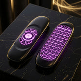 Two glossy black wireless remote control covers shown from the front, one with a directional pad and one with a full keyboard layout, both illuminated with purple LED lighting on a dark surface.