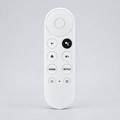White remote control with various buttons on a wooden surface, branded 'Remote Hut'.