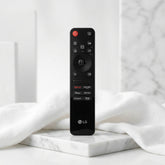 LG remote control on a wooden surface with 'Remote Hut' branding.