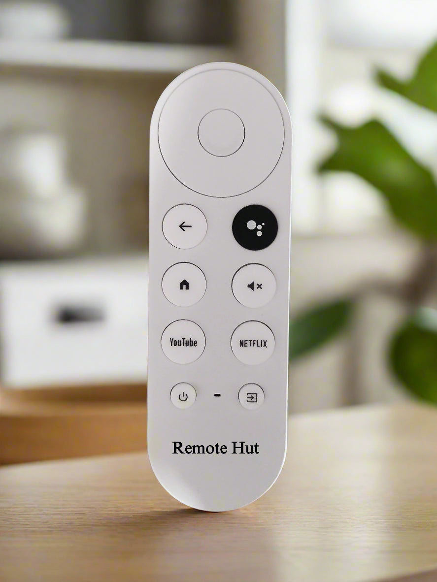 White remote control with various buttons on a wooden surface, branded 'Remote Hut'.